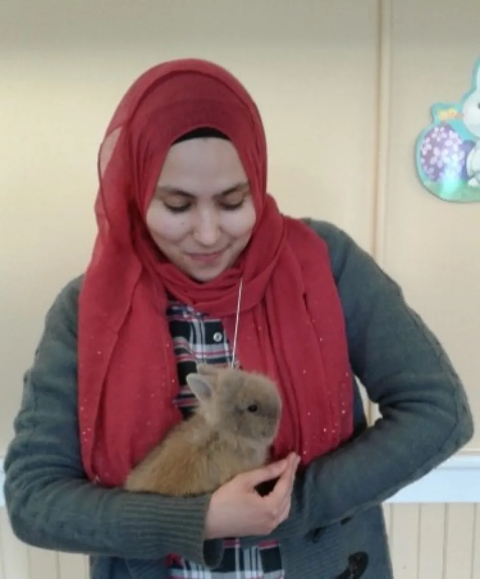Menal Zeghal, a volunteer at the Canada Agriculture and Food Museum, holds a rabbit.