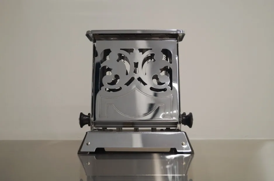 A Canadian-made General Electric toaster, a rectangular metal toaster with two flip-down doors decorated with floral cut-out patterns.