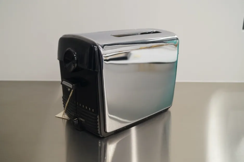 This Westinghouse toaster is a pop-up toaster with a shiny metal exterior, and a plastic interface.