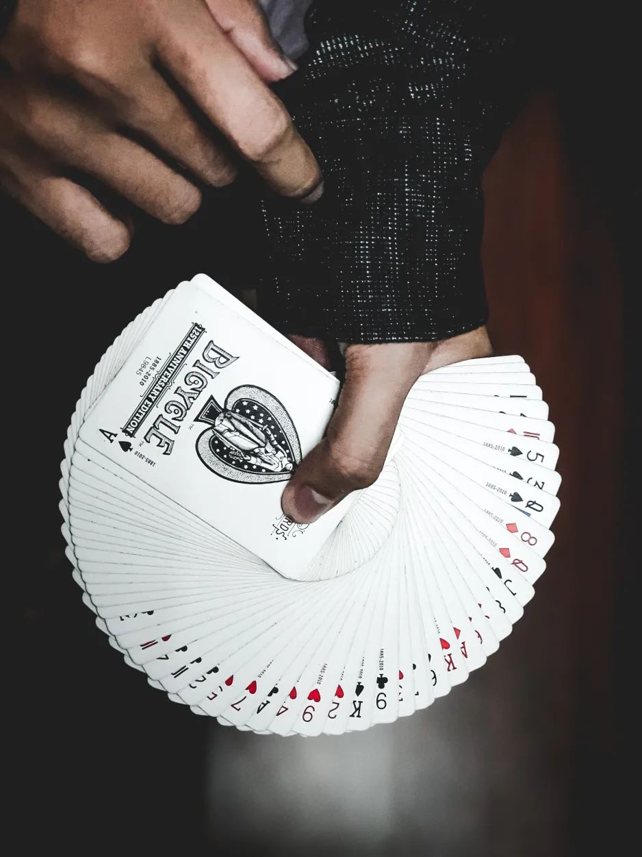 A randomly shuffled deck of cards is held in a fan