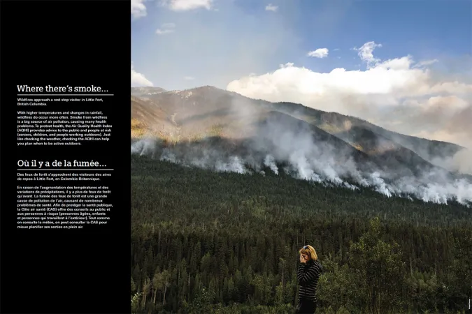 A person covers their face as they stand in front of a mountainous forest covered in smoke.  To the left of the image is a black strip with the title “Where there’s smoke…” above some text.