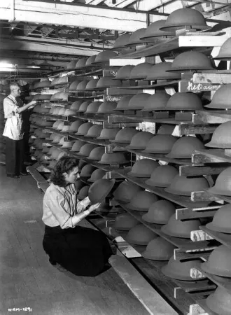 Shelves filled with soldiers' steel helmets at General Steel Wares,