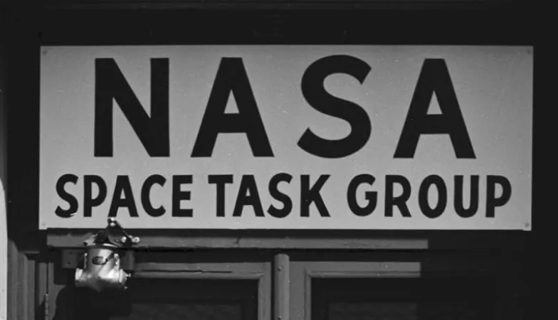 A sign which reads: NASA Space Task Group.