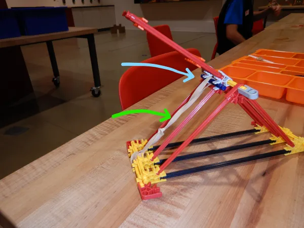 A nearly complete catapult made from K’NEX. Missing is the “cup” where the projectile will sit. 