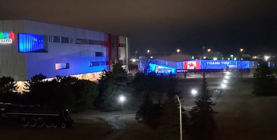 Ingenium Centre building and the Canada Science and Technology Museum lit up in blue