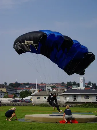 The Dane Jan Bo Kristensen performing a precision landing with a parafoil during a national competition organised by the Dansk Faldskærms Union, Randers, Denmark, August 2005. Wikipedia.