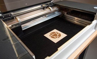The museum's logo sits on a laser cutter.