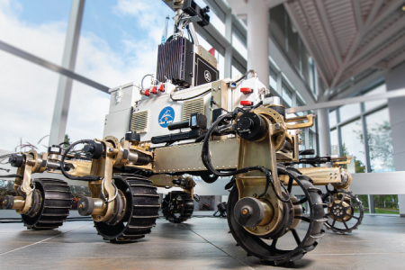 A six-wheeled metallic science rover equipped with a robotic arm to collect rock and soil samples