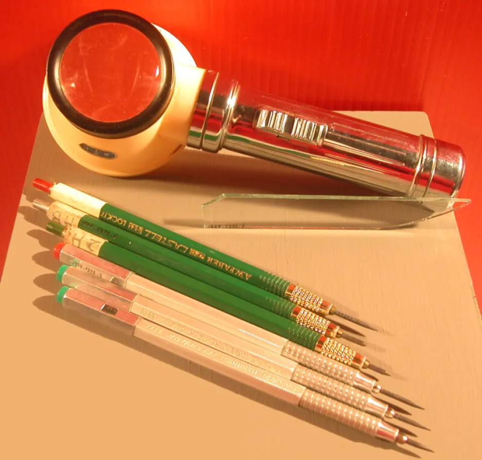 The glass blade, pencils, and magnifying glass used by Karsh to retouch his negatives and prints 