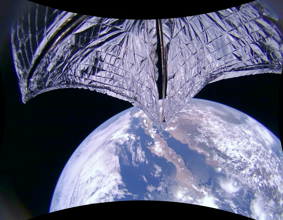 The silver-coloured solar sail of LightSail2 extended fully, with Earth below. Baja California and Mexico are visible.