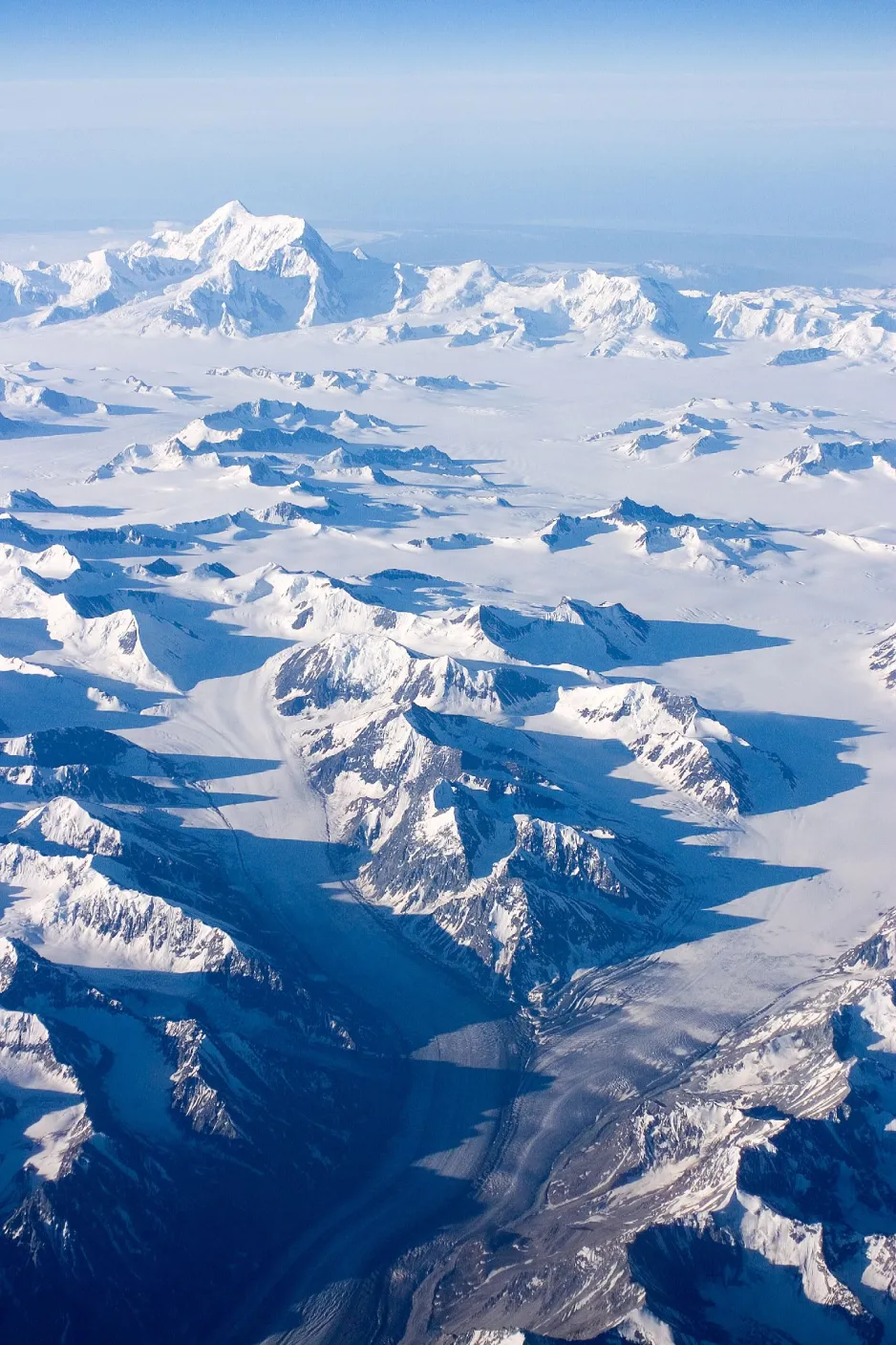An image taken from a plane at 36,000 feet, showing the Saint Elias Mountains covered in snow.