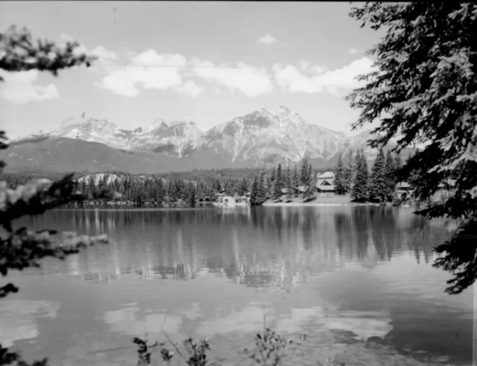 A black-and-white photograph shows a lake in front of a mountain in Jasper, Alberta