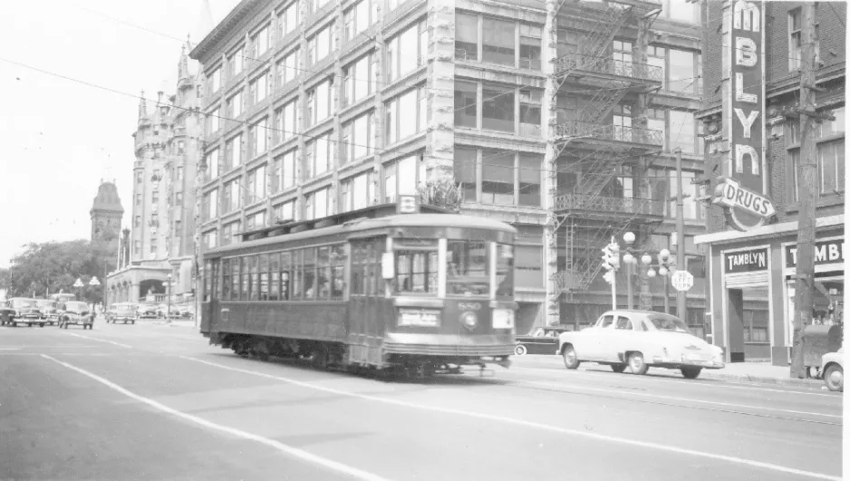 A black and white photo depicts the OTC 854 streetcar in downtown Ottawa.