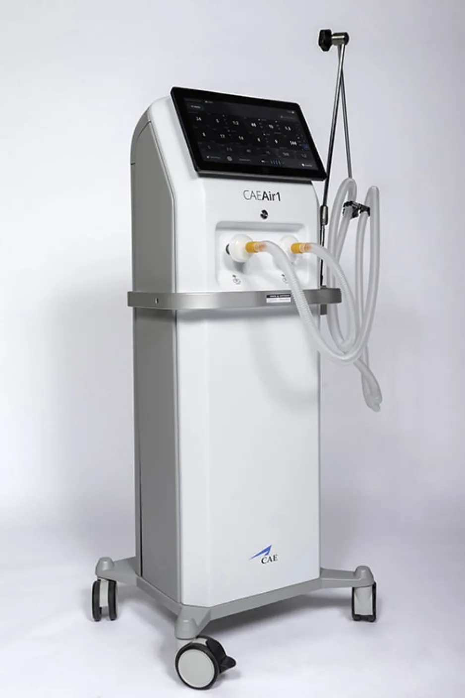 A tall, white-and-grey medical ventilator, with a black display screen, is on wheels.