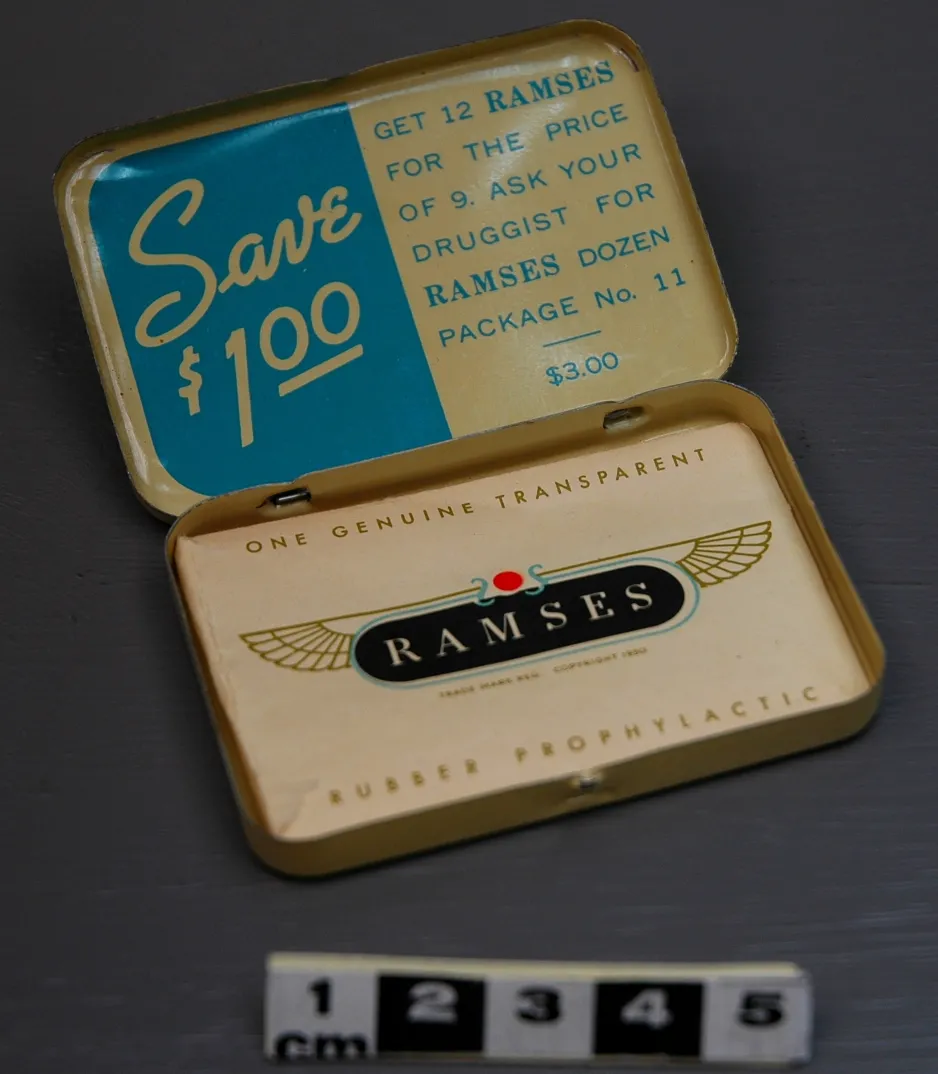 An open tin with “Save $1.00 – Get 12 RAMSES for the price of 9. Ask your druggist for RAMSES dozen package no. 11 - $3.00” in print on the top-inside of the tin and a prophylactic paper cover in the bottom of the tin compartment. 