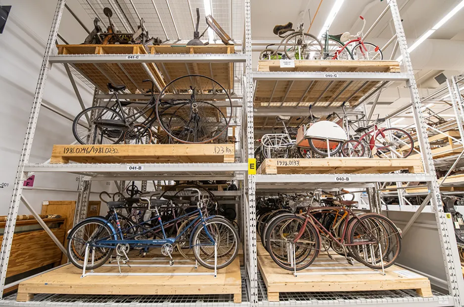 a collection room with shelves of bicycles