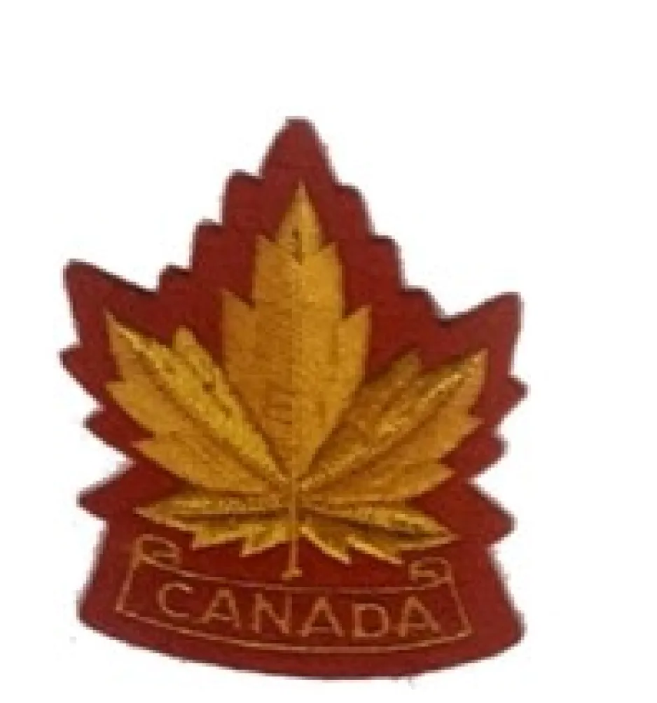 A red and gold Boy Scouts patch with a maple leaf in the centre and a banner reading CANADA underneath.