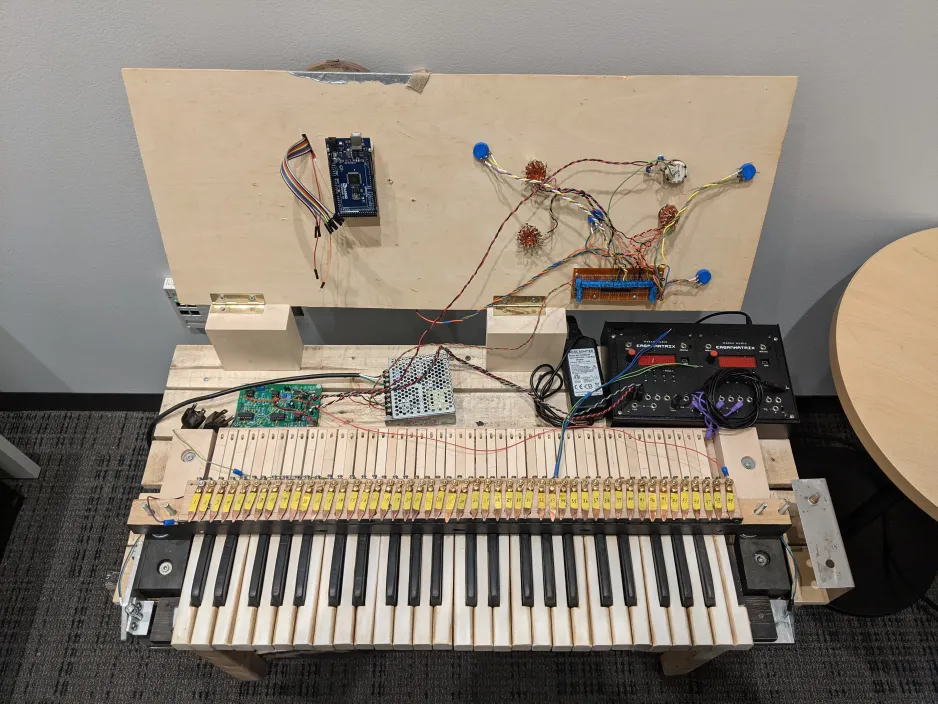 Overhead shot of the reconstructed instrument with the control surface opened up, showing various wires and electronic modules located beneath.