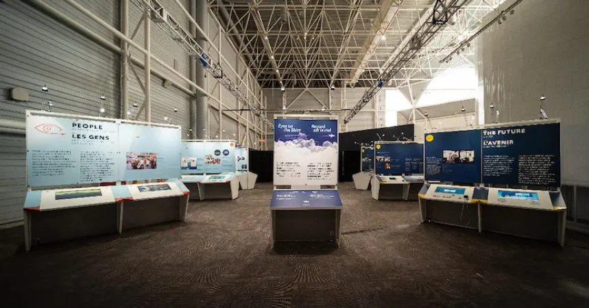 A head-on, wide-angle view of the exhibition showing the introduction panel at the centre.
