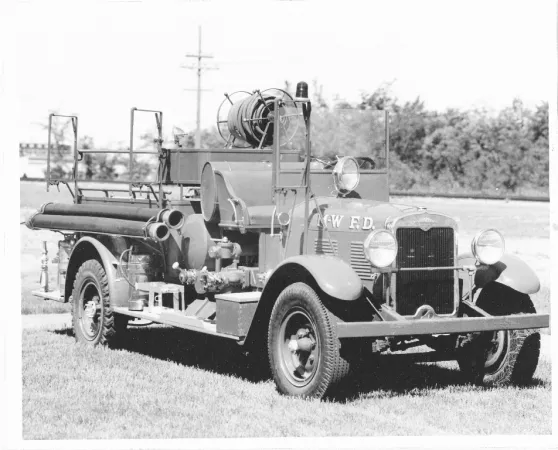 Black and white photograph showing an old fire truck CR K84-135.