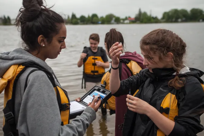 A group of young citizen scientists test water quality.