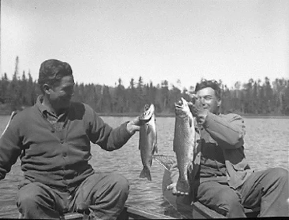 Two guides holding the fish they caught in Bird Lake