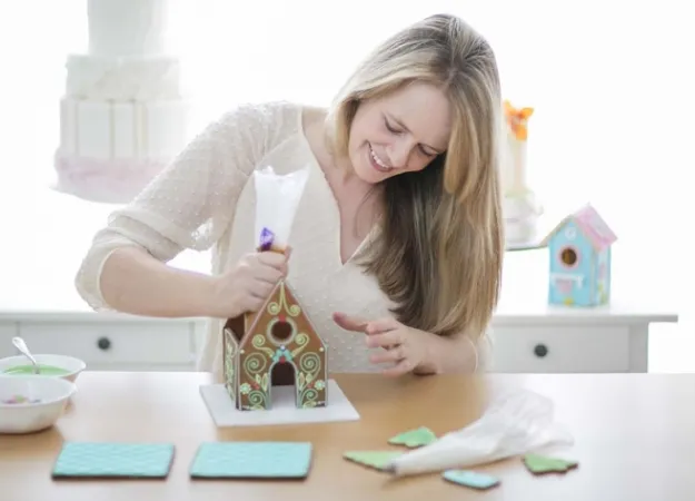 Catherine Beddall assembles a gingerbread house.
