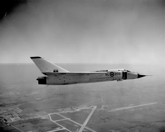 A black-and-white image of a plane in flight.