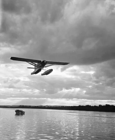 Bellanca CH-300 Pacemaker flying over a lake