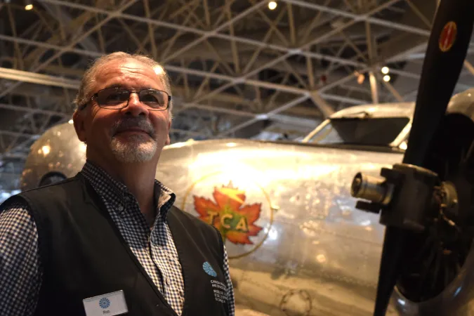 Robert Day stands by the Lockheed 10E Electra, made famous by Amelia Earhart’s attempted trip around the world. 