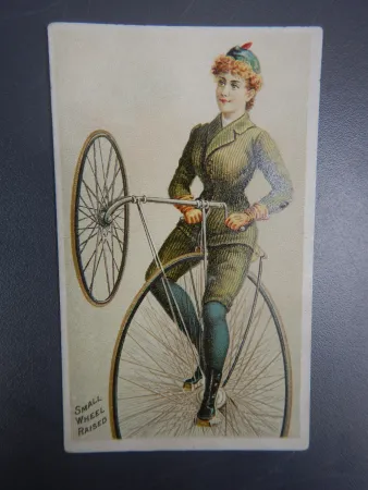 A woman doing a trick on a modified "safety" high wheel bicycle