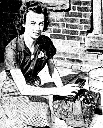 Beth Ross posing for a photographer as she cleaned up the main fragment of the Dresden chondrite in front of the office of The Dresden News. Anon., “Adding lustre to meteor that startled a province.” Toronto Daily Star, 13 July 1939, 1.