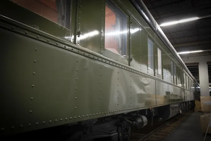A side view of a Governor General’s rail car, with a glossy forest green exterior.