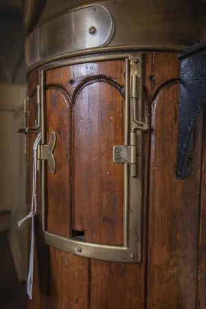 A close-up view of the wooden and brass door of the binnacle.