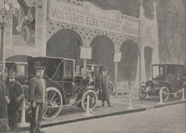 Le kiosque de la Compagnie parisienne des voitures électriques à l’Exposition internationale de l’automobile, du cycle et des sports, Paris, France. Louis Antoine Jules Tony Kriéger se trouve à son entrée. Anon., « Le Salon de l’automobile. » Le Monde illustré, 19 décembre 1903, 551.