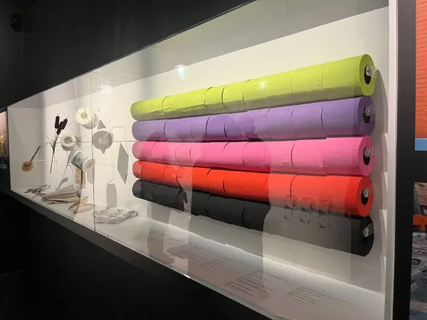 An exhibit with many rolls of colored toilet paper rolls