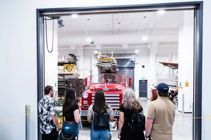 Back view of visitors at the Ingenium Centre admiring a fire engine from the Ingenium collection.
