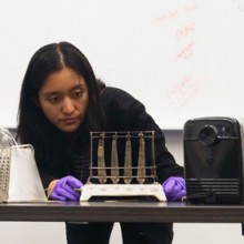 Sophie working with a series of toaster artifacts placed on a worktable.