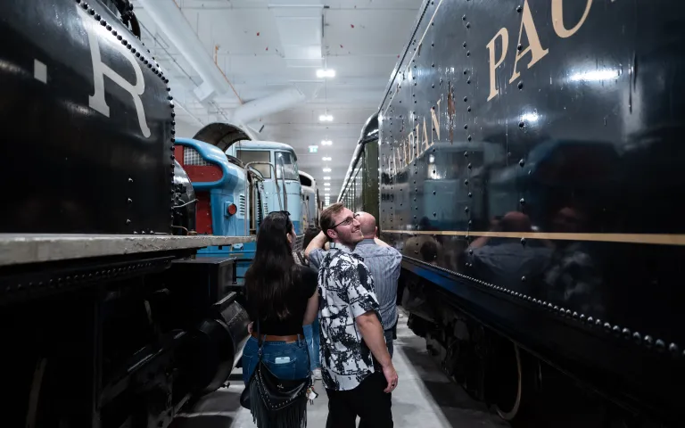 A group of people visiting the Ingenium’s collection and looking at the last steam locomotive built by the Canadian Pacific Railway. 