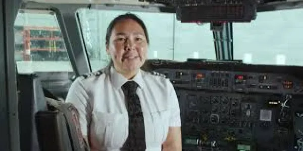 Melissa Haney, a pilot with Air Inuit, sits in the cockpit of an aircraft.
