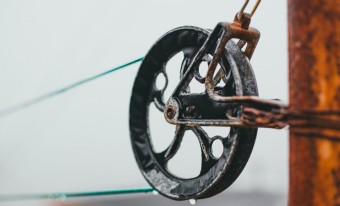 Close up of a pulley on a clothes line.
