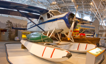 Un hydravion bleu et blanc dans l'exposition sur les avions de brousse du musée.