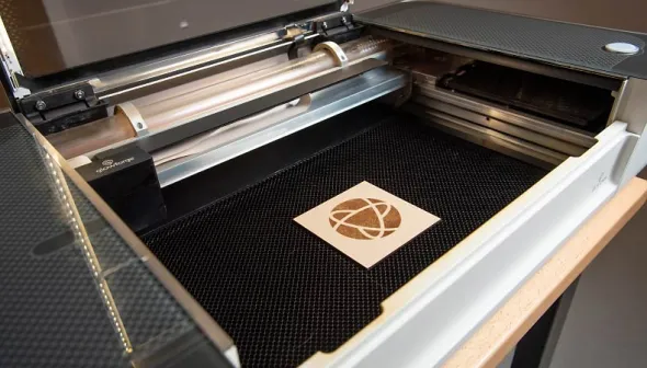The museum's logo sits on a laser cutter.