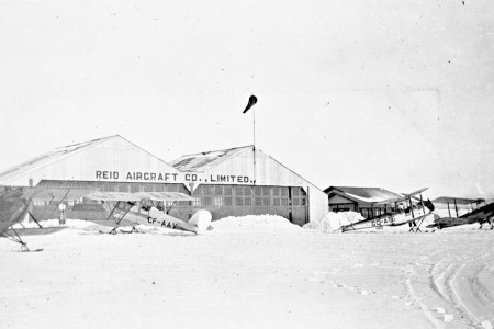 Reid Hangar at Cartierville Airport with aircraft in snowy foreground