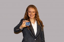 An image of Angeline Lafleur holding up Arduino, a coding tool.